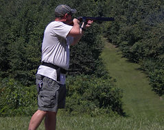 Participant at an outdoor club shooting event.